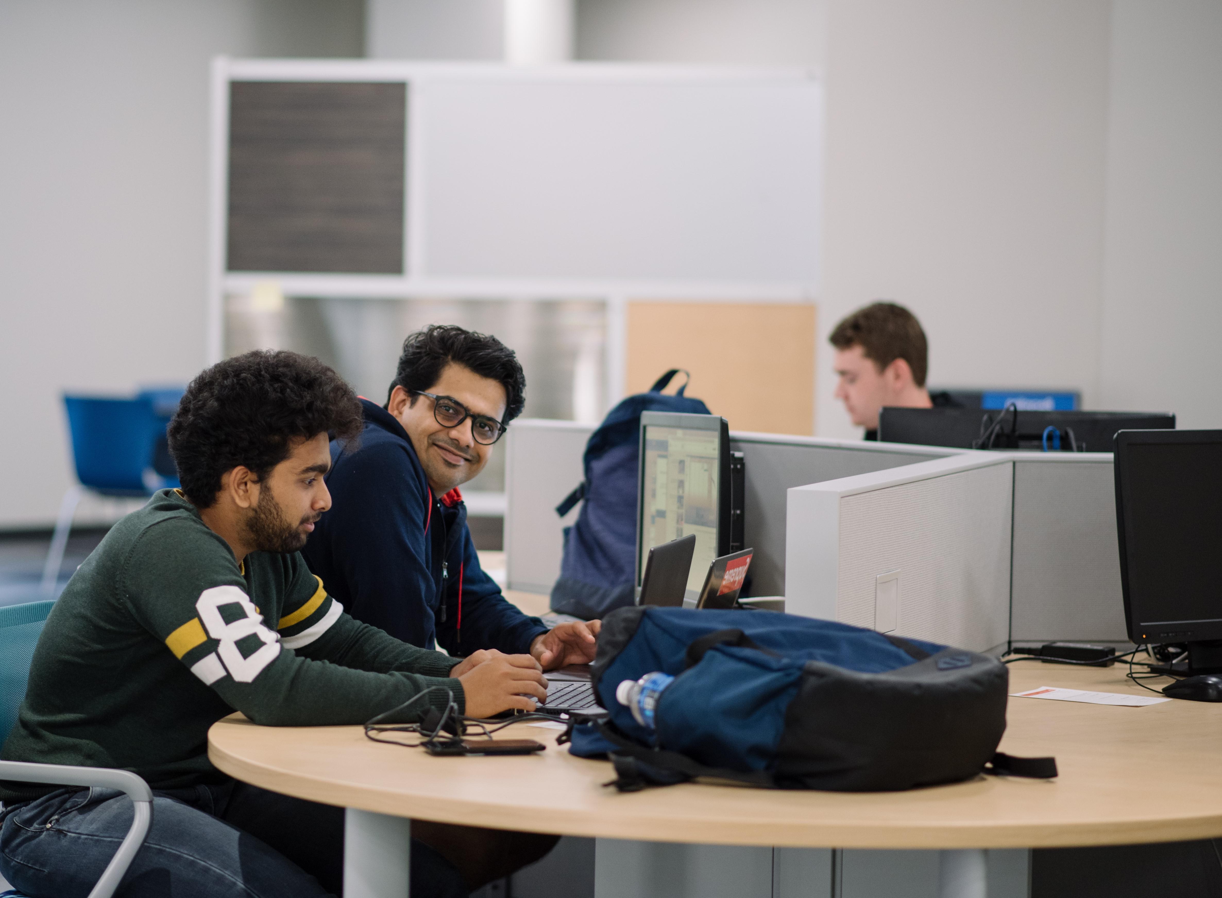 ${ students smiling in the library }